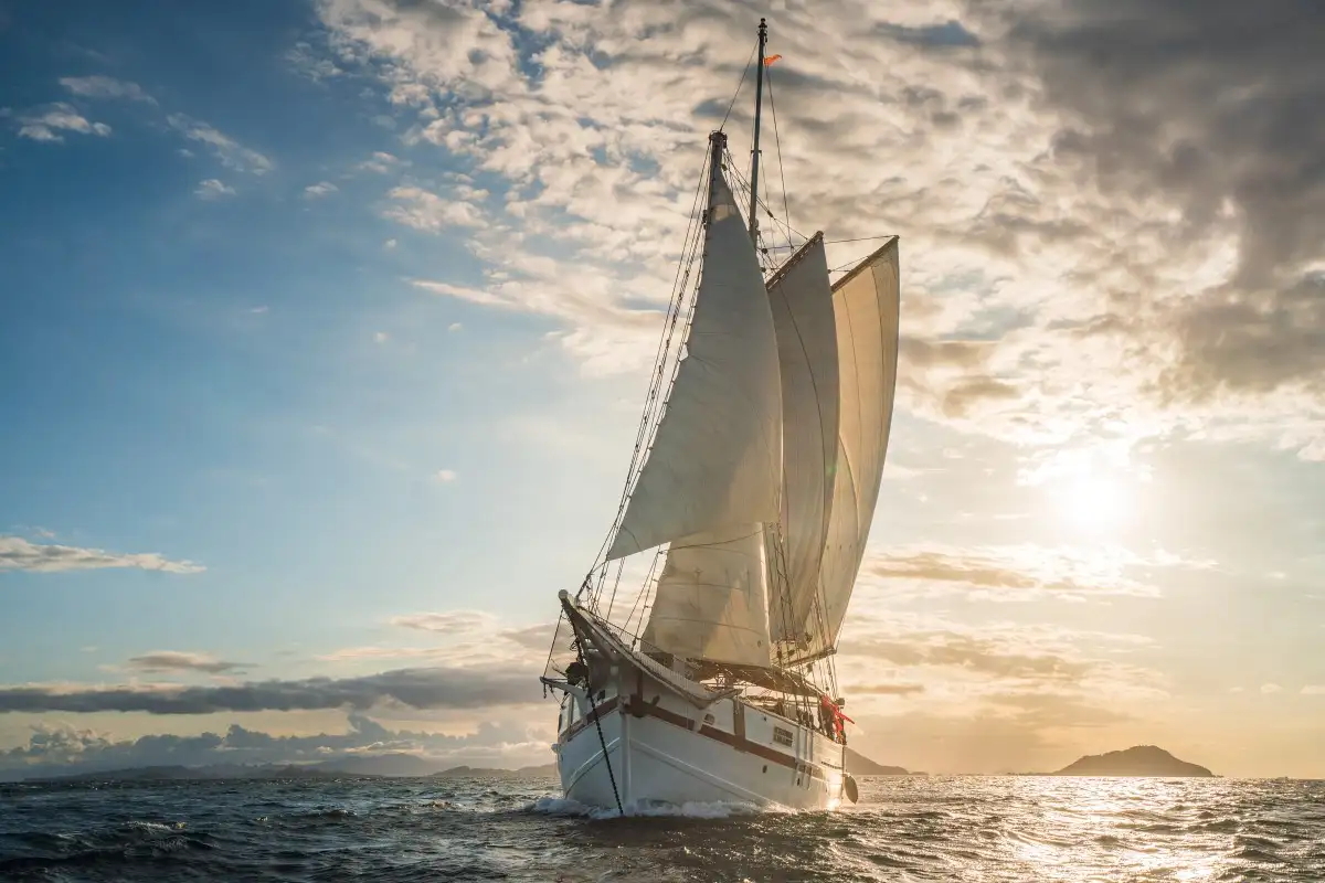 A sailing yacht at anchor in calm water
