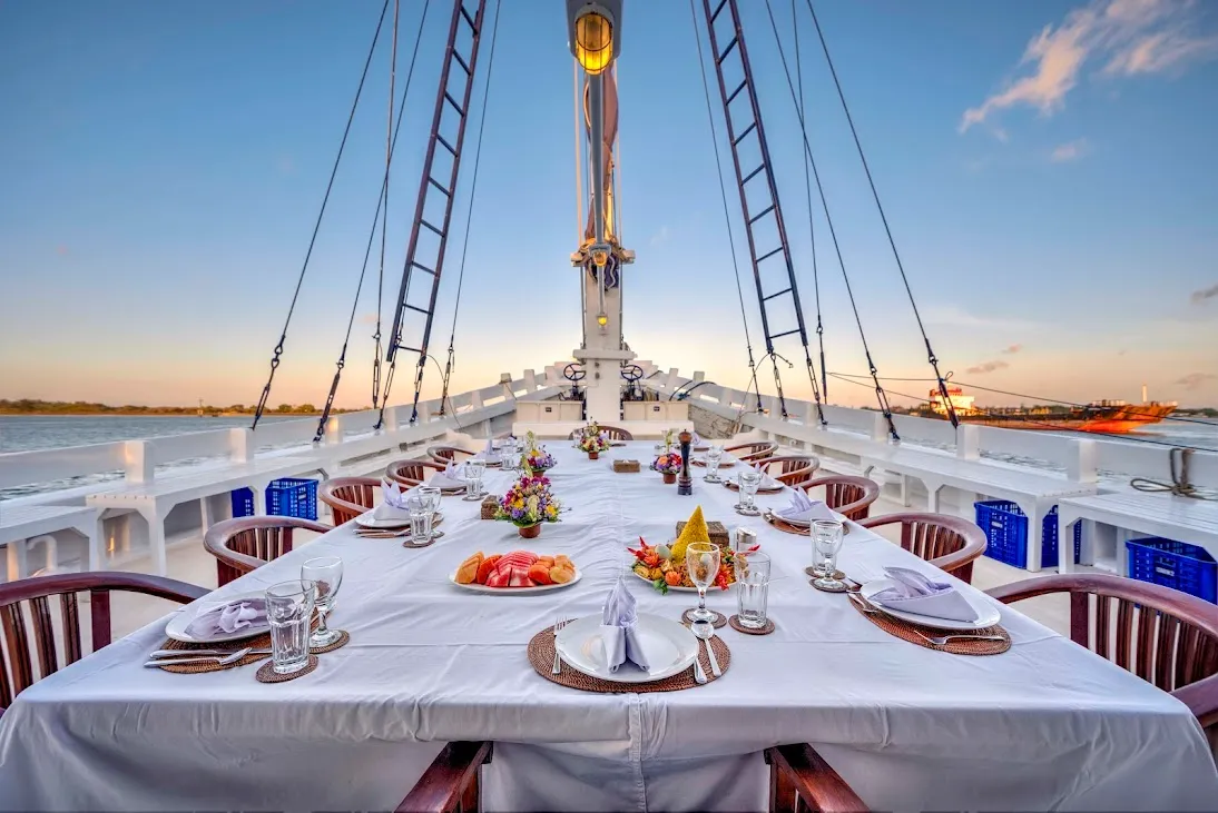 A dinner table set on a yacht deck