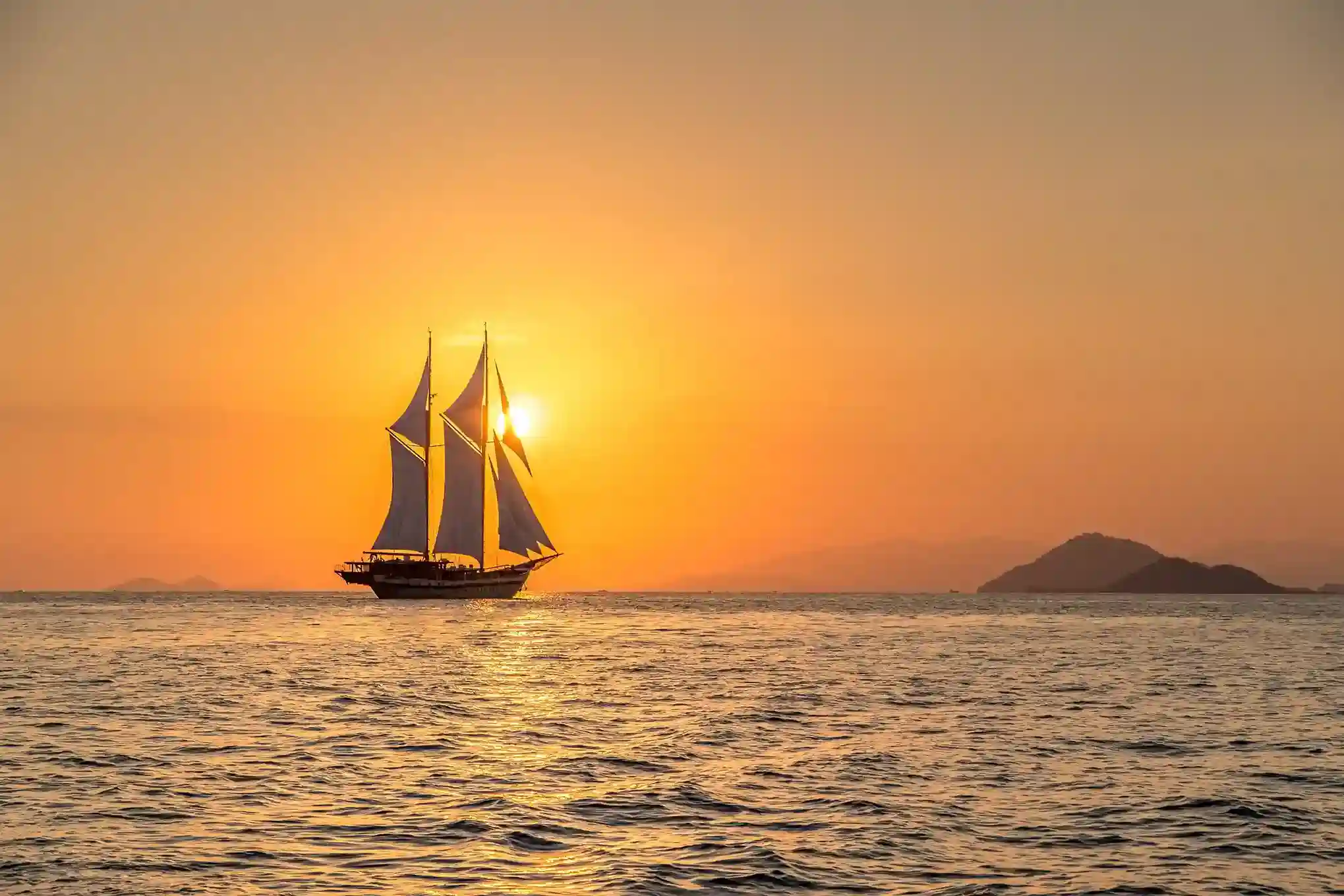 A crewed phinisi under sail in open water