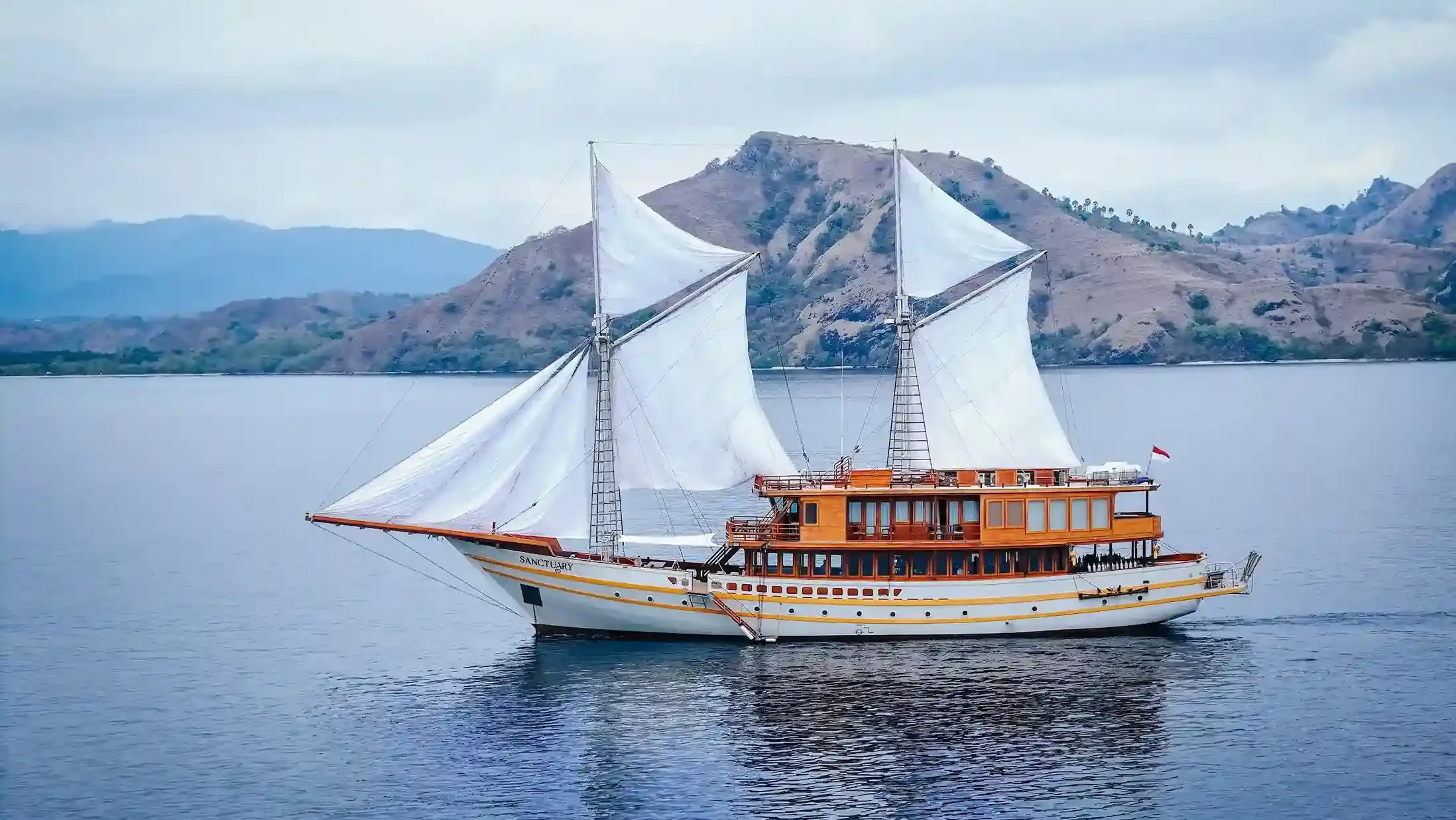 A luxury yacht at anchor at golden hour